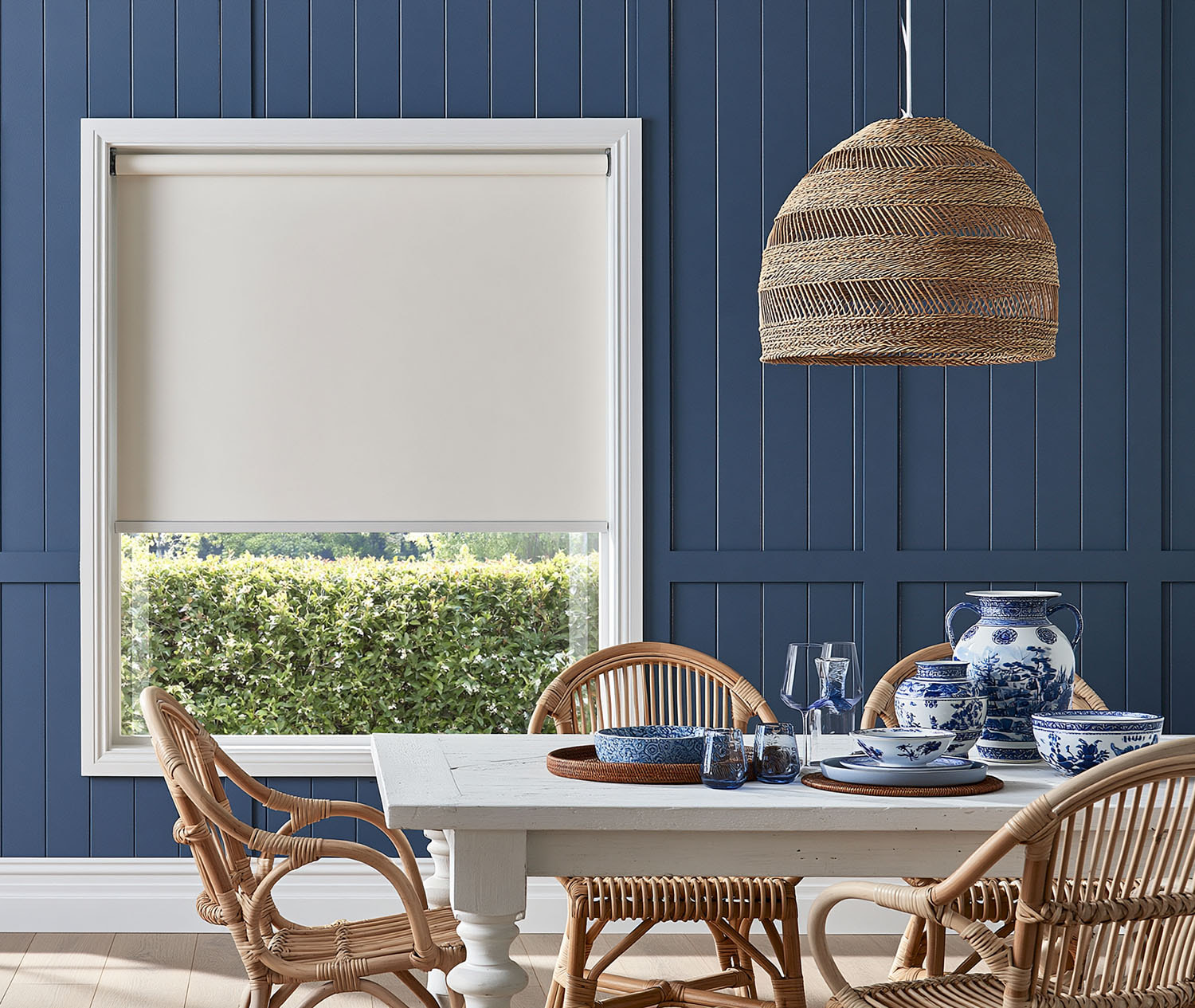Blockout roller blind in a coastal navy dining room