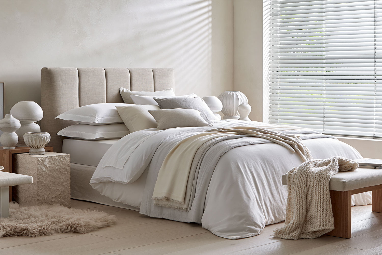 Aluminium venetian blinds fitted in a white minimalist bedroom
